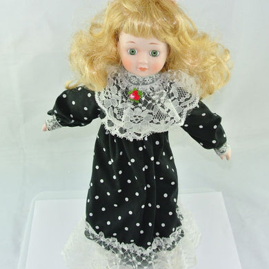 Babypuppe mit schwarzem Kleid / Porzellankopf & Stoffkörper / ca. 37 cm